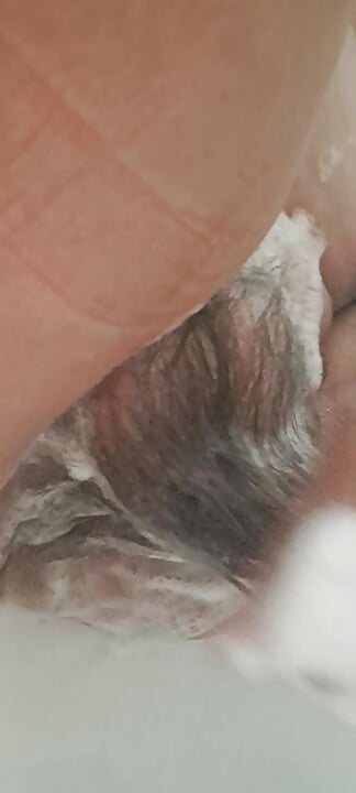 Mature milf washing her hairy pussy